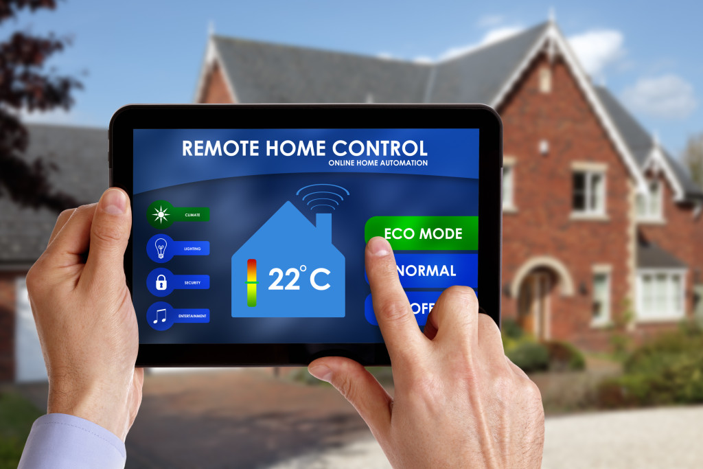 man using a tablet to control house temperature